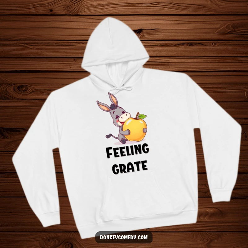 Funny hoodie showing a donkey with an ecstatic grin, happily receiving a giant apple, embodying pure delight.