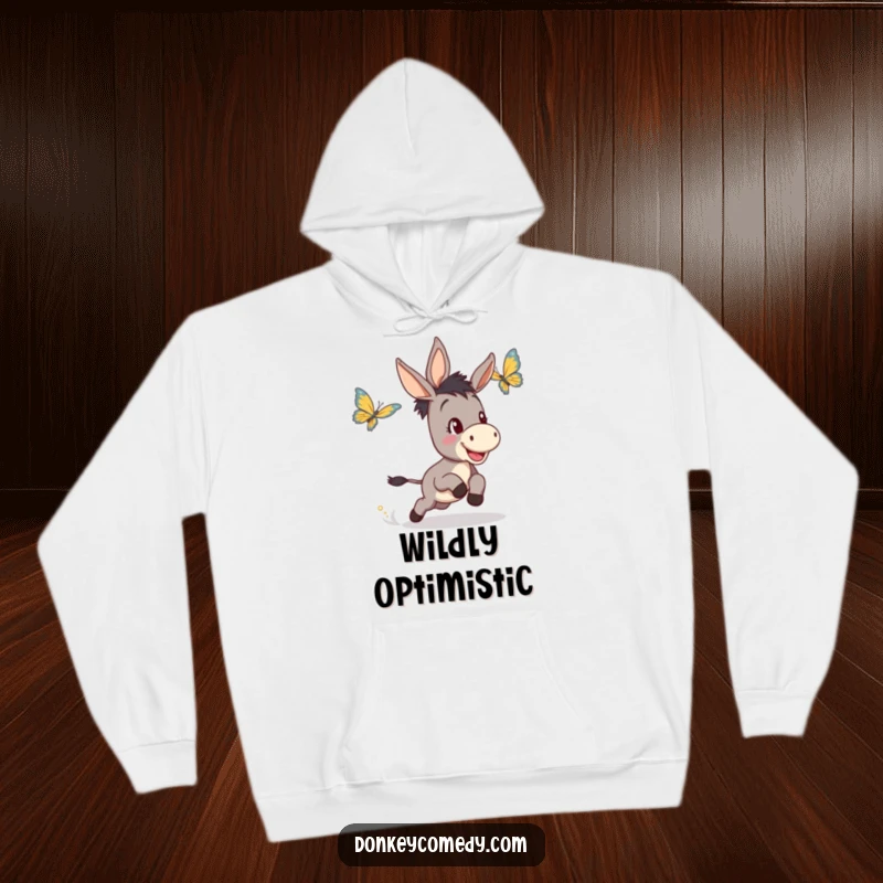 Funny hoodie graphic of a jubilant donkey's determined, happy pursuit of a fluttering butterfly through a sunny meadow.