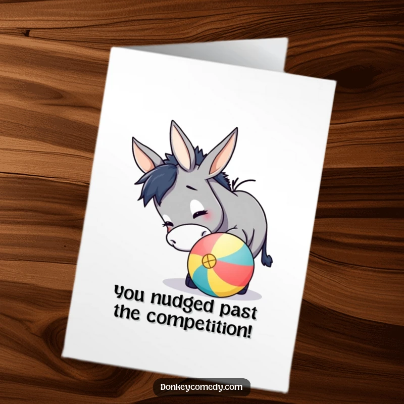 Funny Free Printable Congratulations Card showing a donkey gently nudging a large, colorful ball with its snout, full of playful energy.